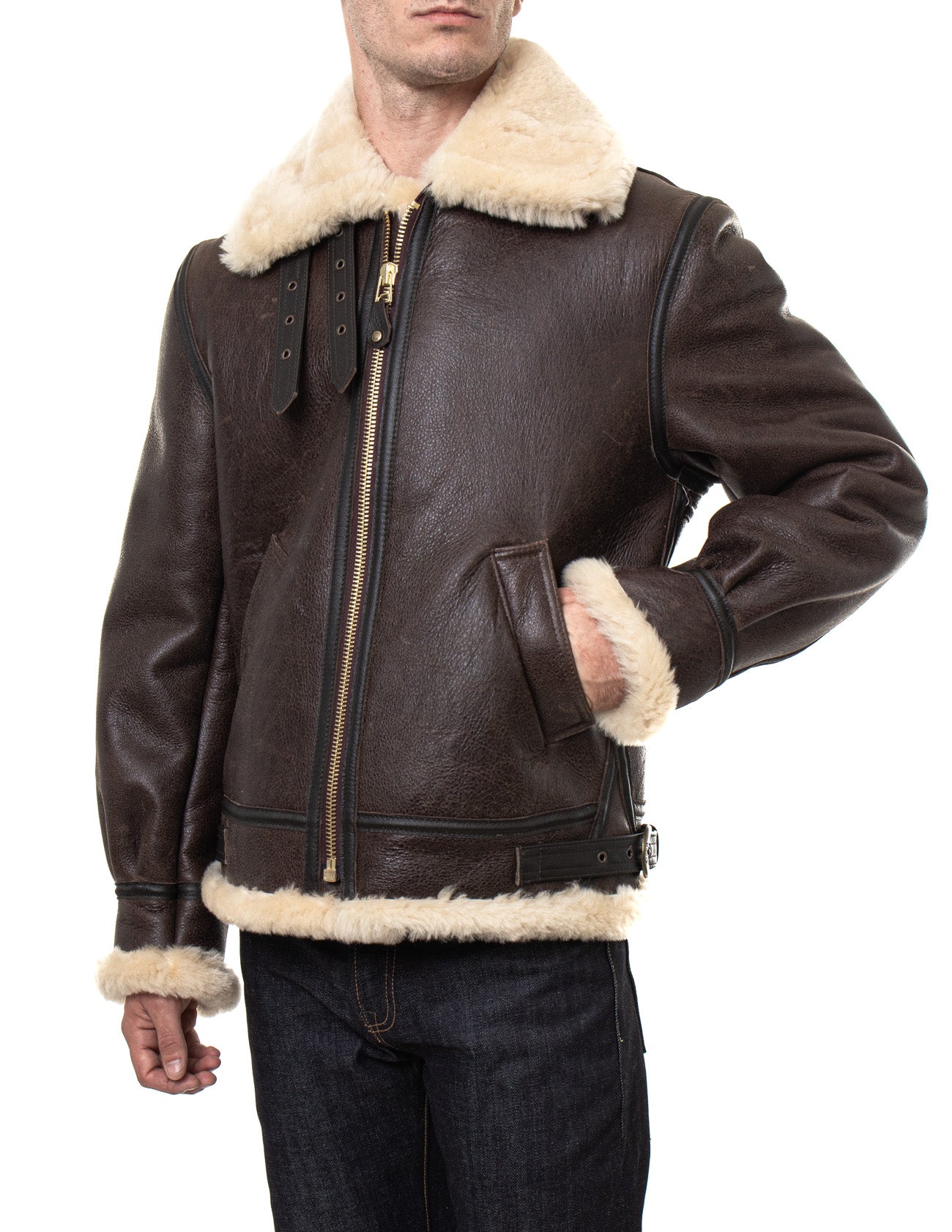 Front view of sheepskin shearling jacket on model with full, cream fur-lining and collar, one hand in pocket fully zipped