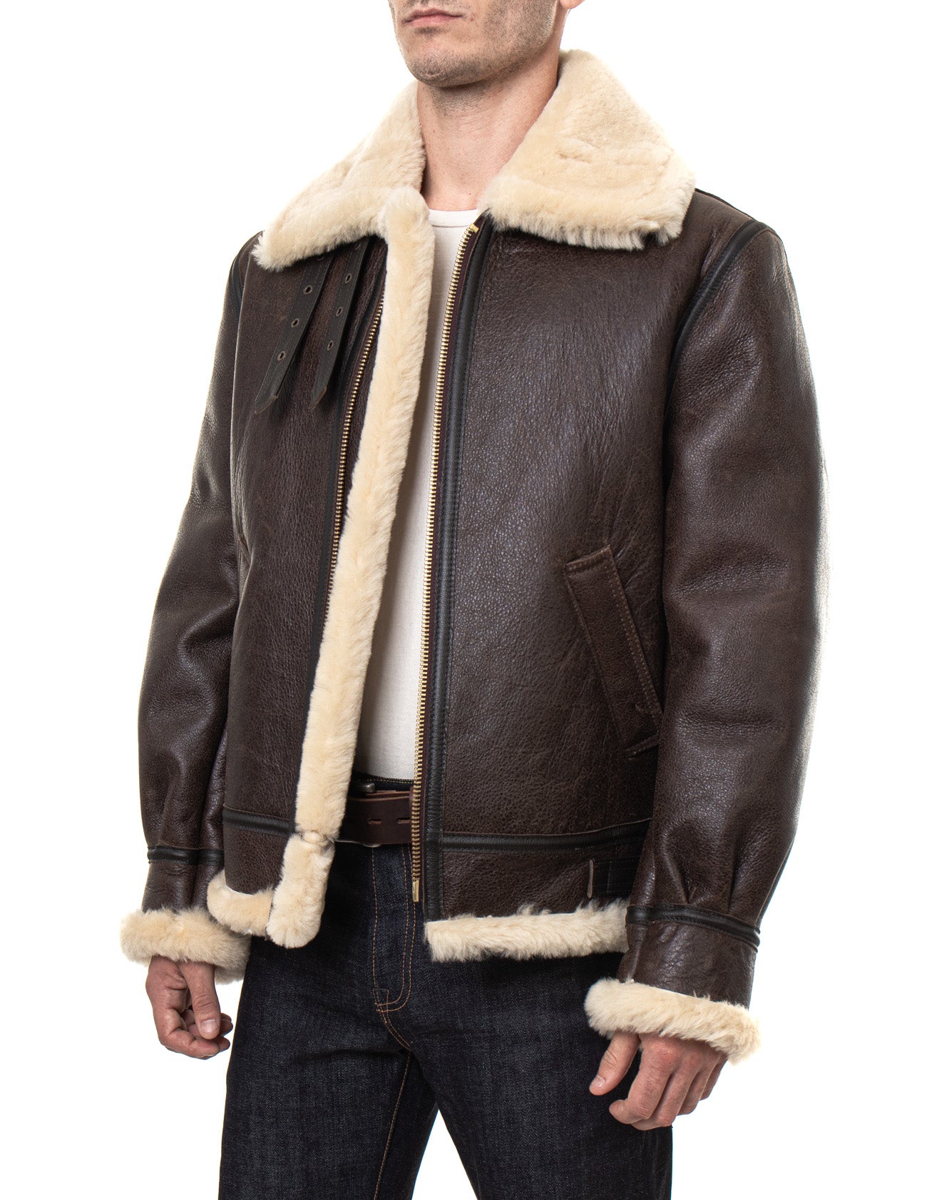 Front angled view of sheepskin shearling jacket on model with full, cream fur-lining and collar, unzipped front